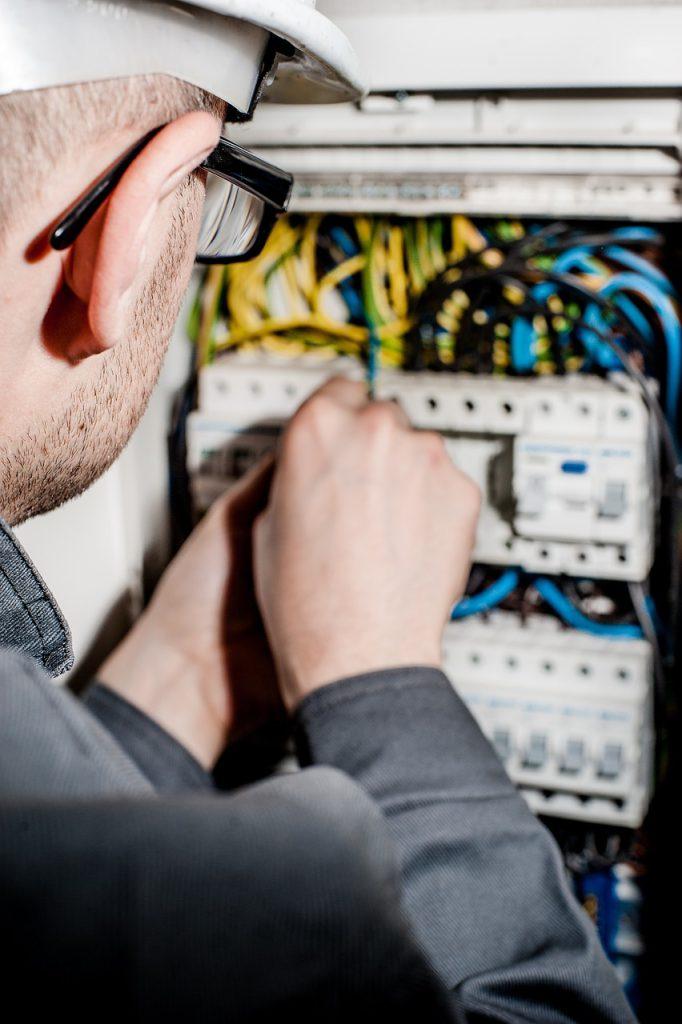 Electrician working on electrical panel.